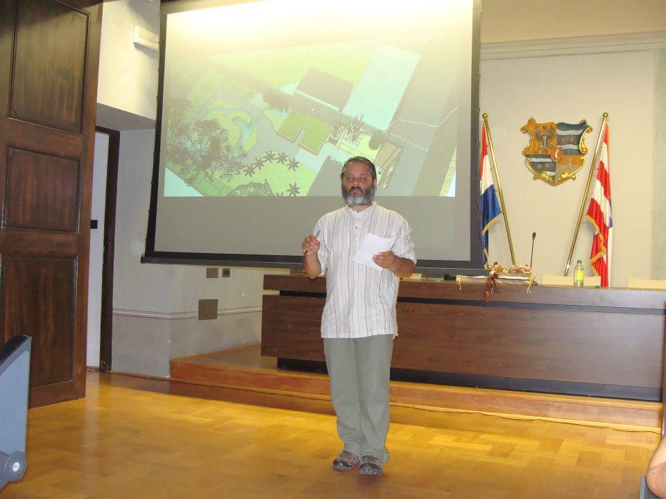 Permaculture design documentation being presented to an audience using a projector